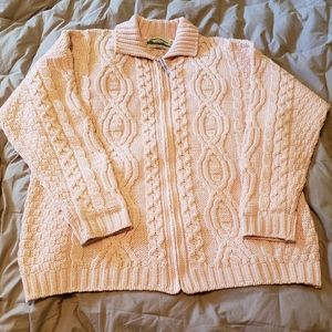 Light pink Arancrafts Merino Wool Irish cable knit zip-front sweater.